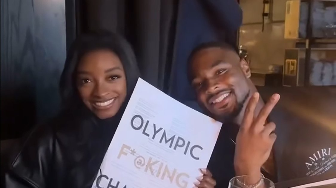 Simone Biles Poses With ‘Olympic F–king Champion’ Menu