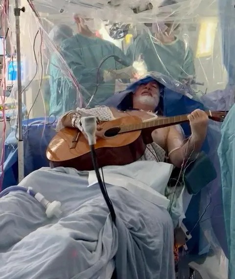 Watch the moment man plays guitar while having brain surgery to remove ‘golf ball-sized’ tumour – The Sun